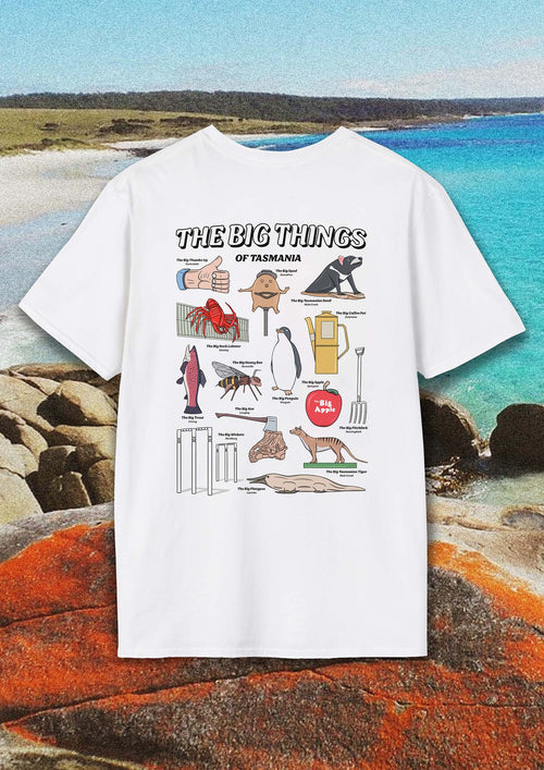 White t-shirt with a cartoon collection of the big landmarks and roadside attractions of Tasmania.. The shirt photo is placed over a film style image of the Bay of Fires. .