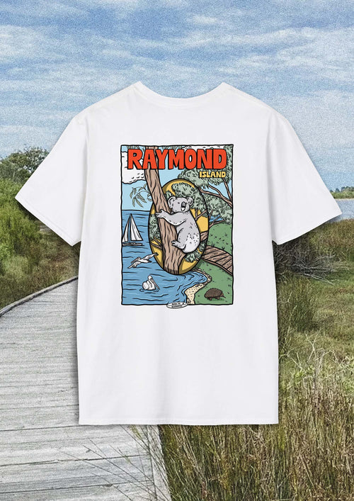 White t-shirt with a cartoon of a koala hanging from a tree with the backdrop of Raymond Islands coast. The shirt photo is placed over a film style image of the Raymond Island coastal boardwalk.